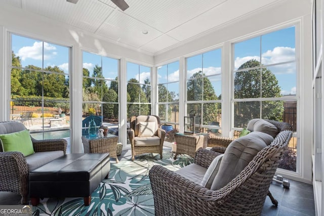 sunroom / solarium featuring a ceiling fan