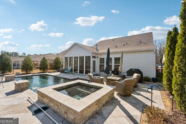 view of swimming pool featuring a patio area, an in ground hot tub, a fenced backyard, and a sunroom