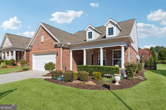 new england style home with brick siding, a garage, concrete driveway, and a front lawn