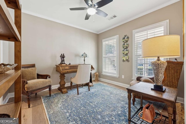 sitting room featuring a wealth of natural light, visible vents, a ceiling fan, and wood finished floors