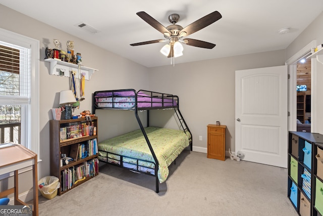 bedroom featuring light carpet, visible vents, baseboards, and ceiling fan