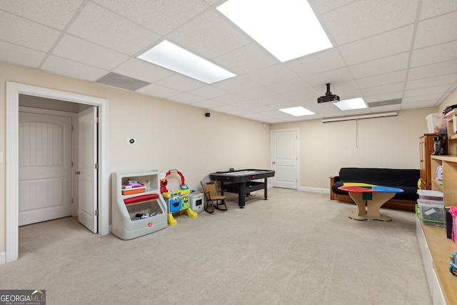 playroom featuring carpet and a drop ceiling