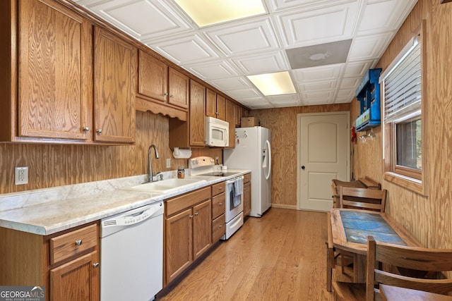 kitchen with white appliances, an ornate ceiling, a sink, light countertops, and brown cabinets