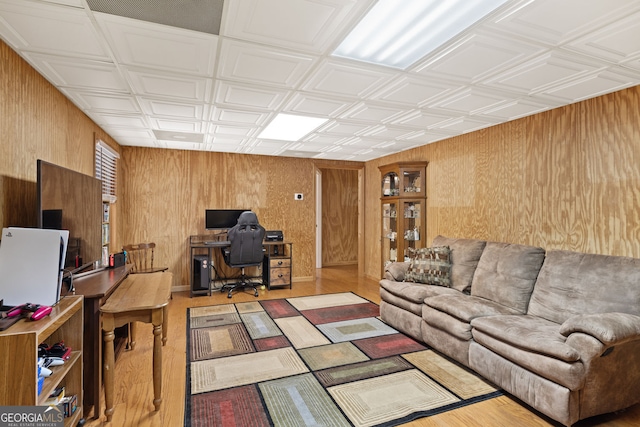 office space featuring wood finished floors, wood walls, and an ornate ceiling