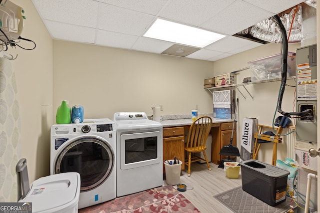 washroom with cabinet space, light wood-style flooring, and separate washer and dryer