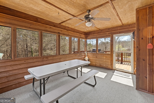 sunroom with wood ceiling and a ceiling fan