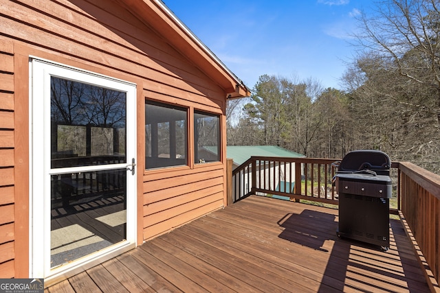 wooden deck featuring area for grilling