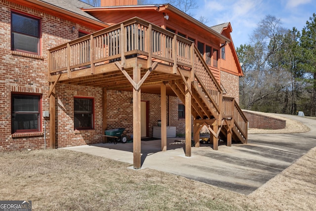 view of patio featuring a deck and stairway