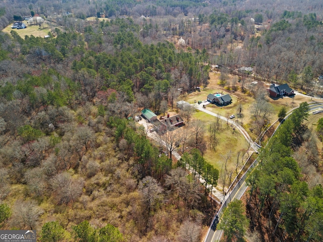 birds eye view of property with a wooded view