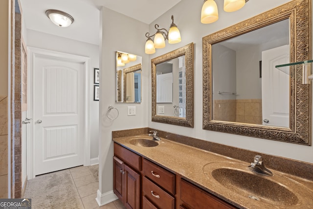 bathroom with tile patterned flooring, double vanity, baseboards, and a sink