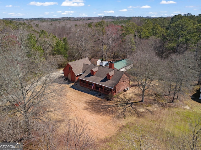 birds eye view of property featuring a forest view