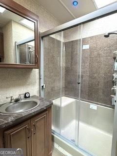 bathroom featuring an enclosed shower and vanity