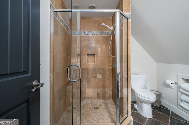 full bath featuring tile patterned flooring, a stall shower, toilet, and vaulted ceiling