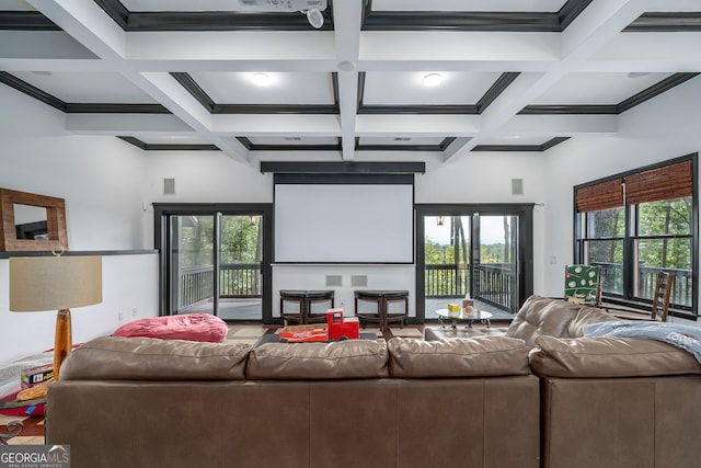 home theater featuring beamed ceiling, coffered ceiling, and ornamental molding