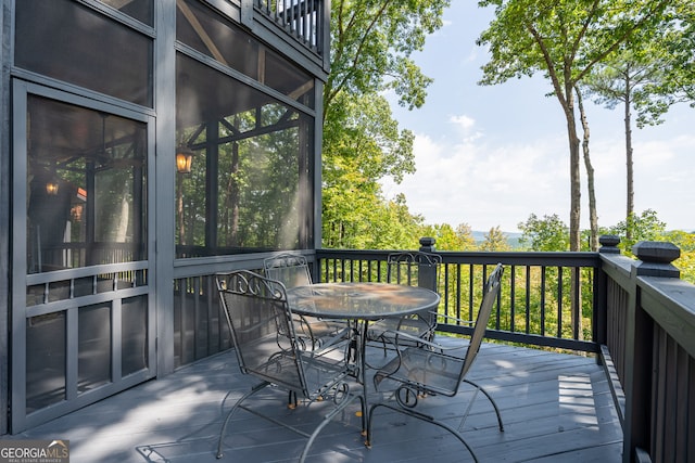 wooden terrace featuring outdoor dining space