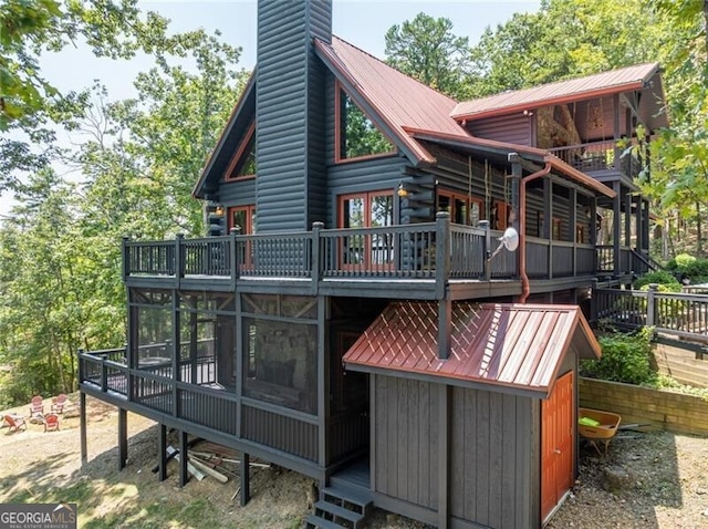 1363 Foxhound Trl NE, Ranger, GA 30734 - back of house featuring a metal roof, a chimney, and a deck