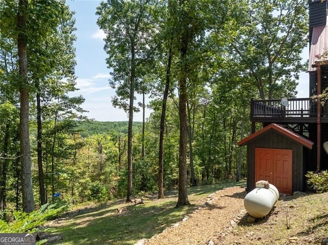 1363 Foxhound Trl NE, Ranger, GA 30734 - view of yard featuring a view of trees and a deck