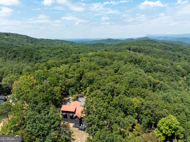 drone / aerial view featuring a mountain view and a wooded view