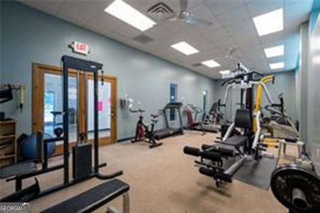 gym featuring visible vents, a paneled ceiling, and ceiling fan