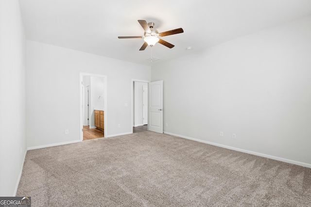 unfurnished bedroom with ceiling fan, baseboards, ensuite bathroom, and carpet flooring