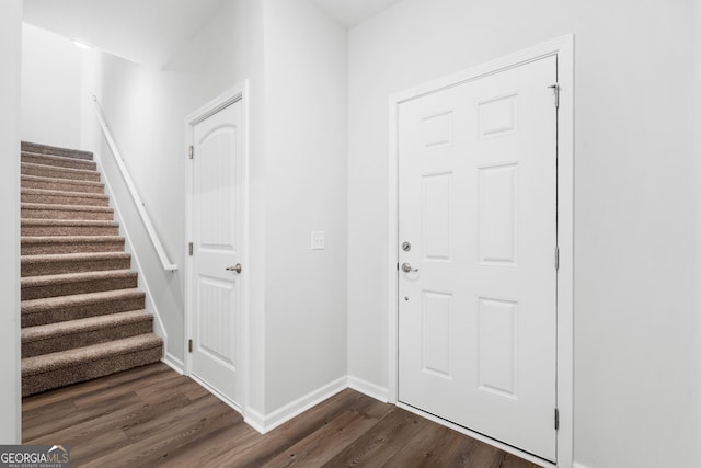 entrance foyer with baseboards, dark wood finished floors, and stairs