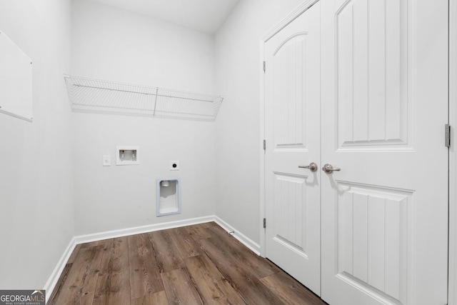 clothes washing area featuring hookup for a washing machine, baseboards, dark wood finished floors, laundry area, and electric dryer hookup