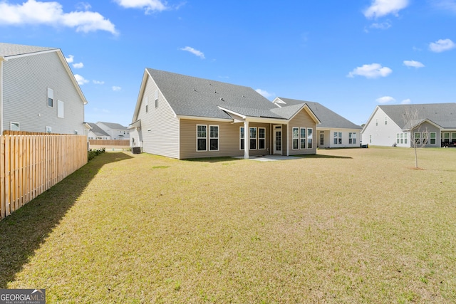 rear view of house with a patio area, central air condition unit, a lawn, and fence