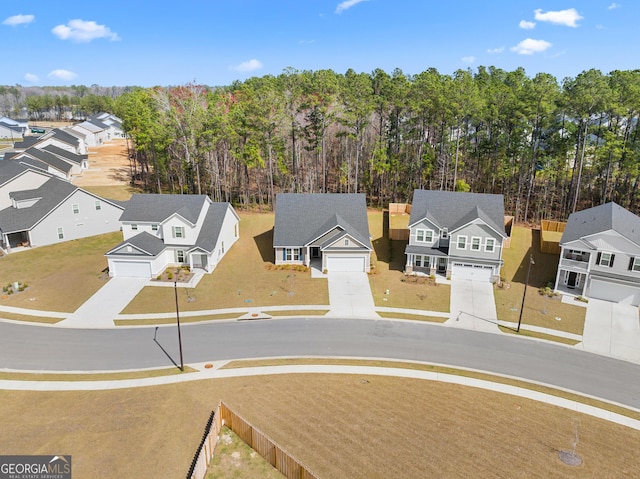 drone / aerial view with a residential view and a wooded view