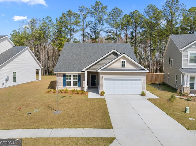 craftsman inspired home with a garage, concrete driveway, and a front yard