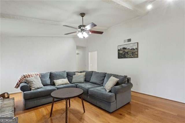 living room with visible vents, ceiling fan, lofted ceiling with beams, and light wood-style floors