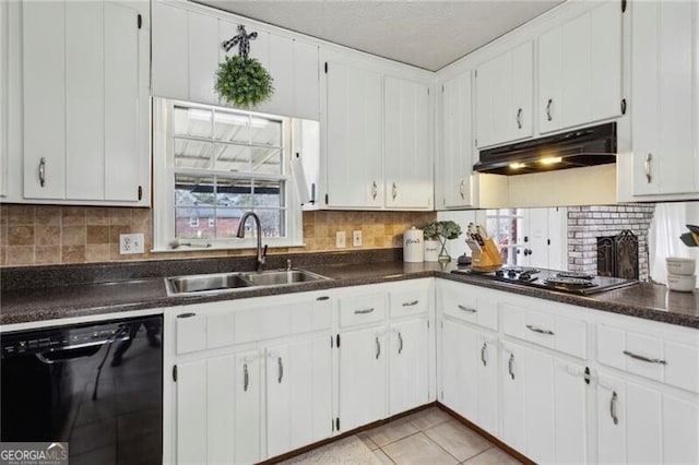 kitchen featuring dark countertops, under cabinet range hood, dishwasher, electric stovetop, and a sink