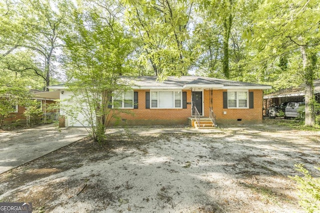 view of front facade featuring brick siding, crawl space, and concrete driveway