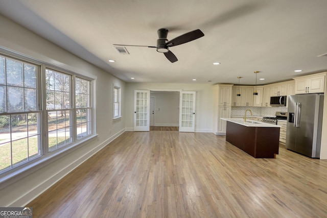 kitchen featuring visible vents, ceiling fan, french doors, stainless steel appliances, and a sink