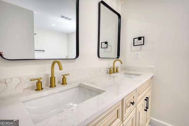 bathroom featuring double vanity, recessed lighting, visible vents, and a sink