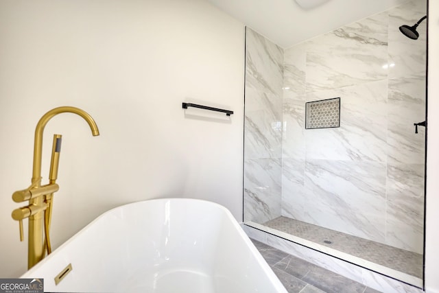 full bathroom featuring a soaking tub and tiled shower