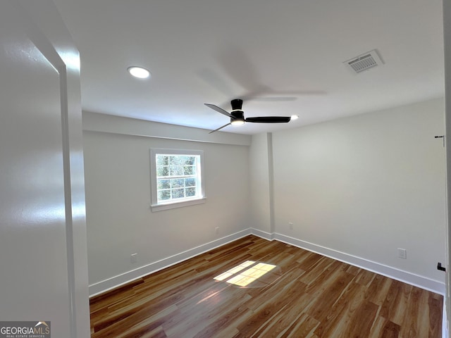 unfurnished room featuring wood finished floors, baseboards, visible vents, recessed lighting, and ceiling fan