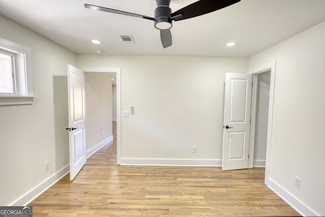 unfurnished bedroom featuring visible vents, baseboards, and light wood-style flooring