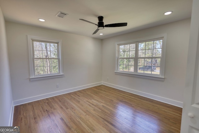 unfurnished room featuring visible vents, a ceiling fan, wood finished floors, recessed lighting, and baseboards