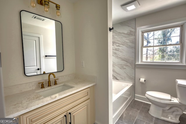 bathroom featuring visible vents, baseboards, toilet, and vanity