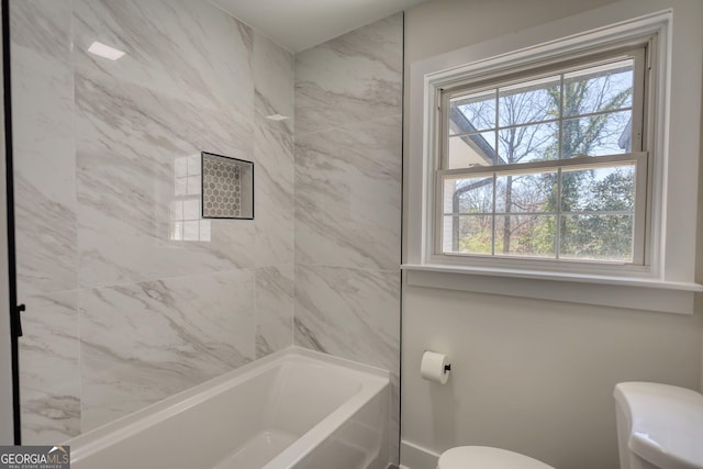 full bathroom with toilet, bathing tub / shower combination, and baseboards