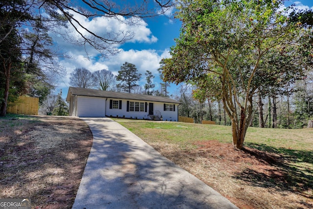 ranch-style house featuring concrete driveway, a garage, fence, and a front lawn