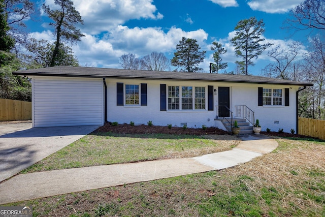 ranch-style home featuring a front yard, fence, and brick siding