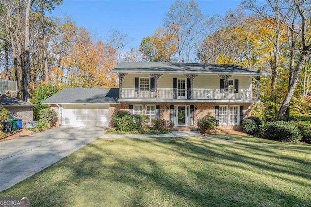 view of front of house with a front yard, a balcony, driveway, a porch, and an attached garage