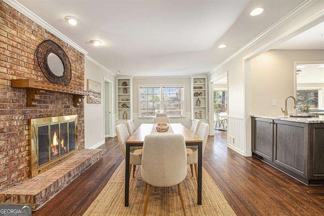 dining room with dark wood finished floors, plenty of natural light, and built in features