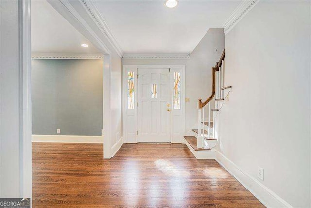 entrance foyer featuring crown molding, baseboards, stairway, recessed lighting, and wood finished floors