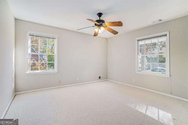 spare room featuring visible vents, baseboards, and ceiling fan