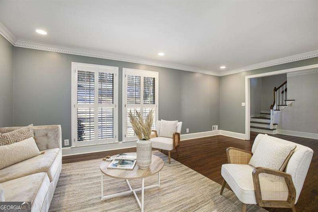 sitting room featuring stairway, wood finished floors, baseboards, recessed lighting, and crown molding