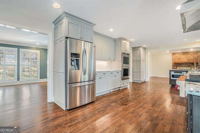 kitchen with dark wood-type flooring, gray cabinets, and appliances with stainless steel finishes