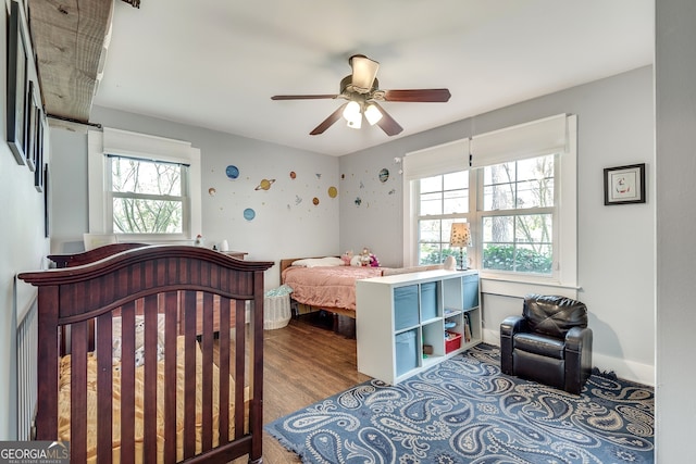 bedroom with wood finished floors and a ceiling fan