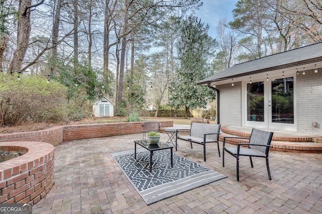 view of patio / terrace with an outdoor structure, french doors, fence, and a shed